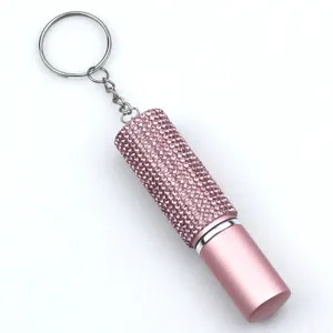 Close-up view of pink rhinestone-studded 5ml refillable perfume spray bottle keychain.