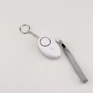 Close-up of white oval personal security alarm with keychain and grey wrist strap