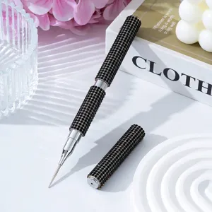 Detailed view of a luxury double-ended nail art dotting pen encrusted with black rhinestones