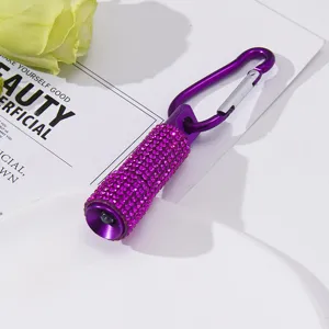 Close-up detail of a fashion purple rhinestone mini LED flashlight keychain with carabiner