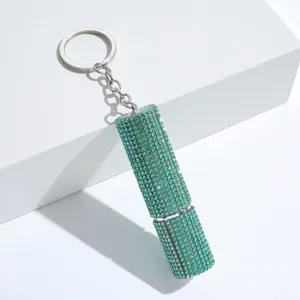 Macro view of a luxurious mint green rhinestone encrusted refillable perfume bottle keychain.