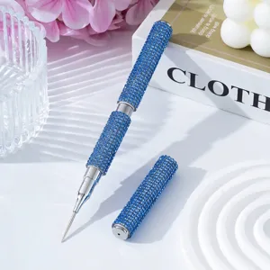 Detail view of double-ended nail art dotting pen covered in sparkling blue rhinestones