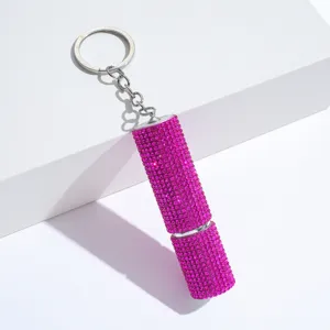 Detailed macro view of a sparkling pink rhinestone-studded perfume refill bottle keychain