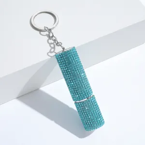 Detailed view of the portable blue rhinestone perfume atomizer keychain for women