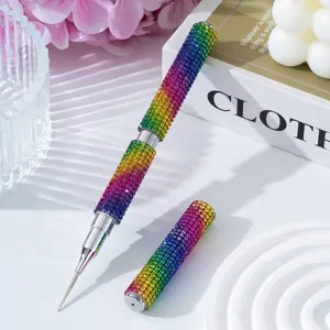 Close-up of a double-ended nail art pen fully covered in colorful rainbow rhinestones