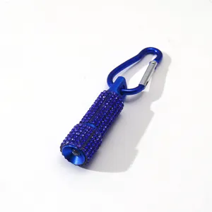 Detail view of stylish blue rhinestone mini LED flashlight keychain with carabiner.