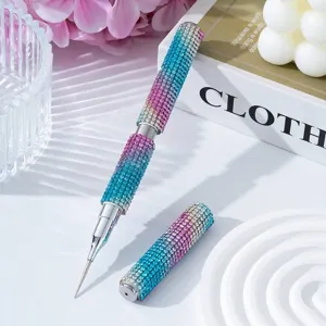 Macro detail of a dual-ended nail art pen featuring sparkling gradient blue and pink rhinestones.