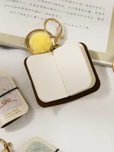 Mini PU leather notebook keychain with cute fluffy pom-pom charm and metal clasp for bags.