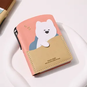 Detail of cute bear pocket notebook with pink leather cover and gold lettering
