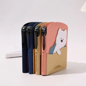 Detailed view of colorful mini portable pocket notebooks with pen slots and cute bear
