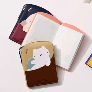 Close-up of a cute mini pocket notebook featuring a cartoon cat design and PU leather cover.