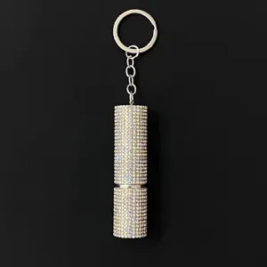 Close-up of shiny rhinestone-studded 5ml refillable perfume bottle atomizer keychain.