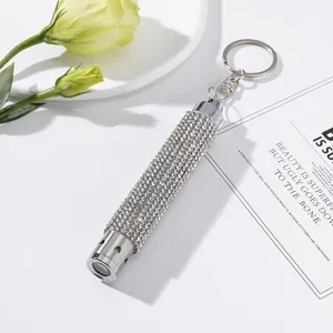 Elegant mini LED flashlight keychain with sparkling silver rhinestone finish and heart detail.