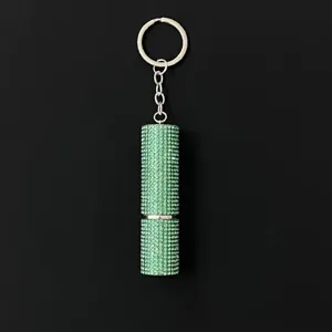 Detailed view of the sparkling green rhinestone-covered 5ml perfume atomizer keychain