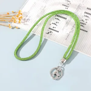 Close-up of green rhinestone phone lanyard with silver metal lobster clasp