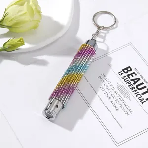 Close-up view of a colorful rhinestone-studded mini LED emergency flashlight keychain