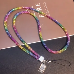 Close-up detail of a luxurious sparkling rainbow rhinestone mobile phone lanyard strap