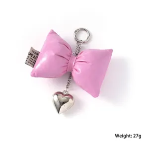 Pink leather puffer bow keychain with silver heart charm and size specifications