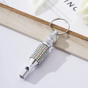 Detailed view of silver rhinestone aluminum alloy whistle keychain for outdoor