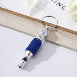 Detail view of survival whistle keychain with shiny blue rhinestones and silver metal finish