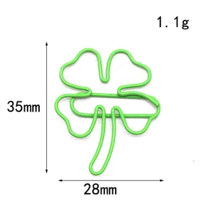 Green clover paperclip detail shot, cute metal bookmark and stationery clip for office or school use.