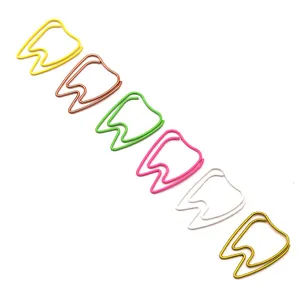 Colorful tooth-shaped metal paper clips detail, creative office stationery and document clips.