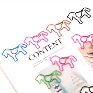 Close-up of cute horse-shaped colorful paper clips on a lifestyle magazine page
