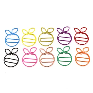 Detailed view of colorful creative orange shaped metal paper clips, cute memo clips.