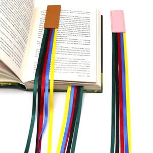 Leather magnetic ribbon bookmark with colorful strings for books, ideal for students and reading.