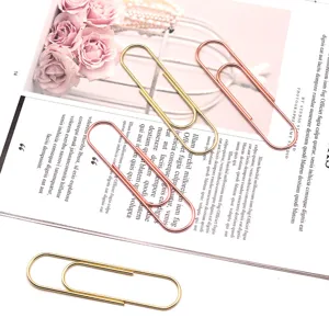 Detail view of large 100mm metal paper clips in gold and rose gold, perfect for office use.