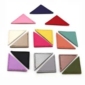 Colorful triangle PU leather bookmarks and paper clips detail view, office stationery accessories.