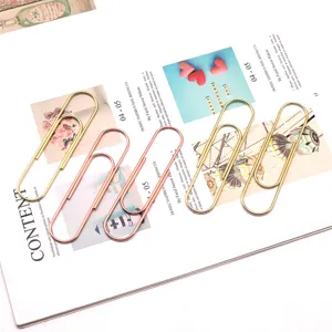 Large 100mm metal paper clips in gold and rose gold for office document organization detail view.