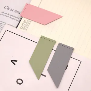 Detailed view of minimalist faux leather bookmarks in pink, green and grey, geometric style.