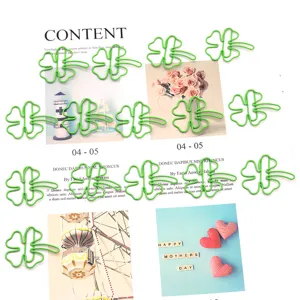 Green clover paper clips detail view, cute metal bookmark and planner binder clips for stationery.