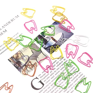 Creative tooth-shaped colored metal paper clips for office stationery and document organization.