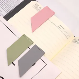 Closeup of minimalist faux leather magnetic corner bookmarks in multi colors for notebooks.