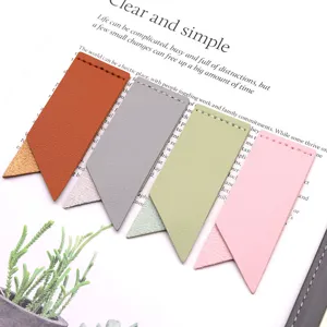 Detailed closeup view of colorful leather page corner bookmarks in a cozy reading setup.