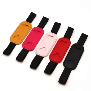 Close-up of colorful PU leather elastic pen holder bands with cute heart cutouts for notebooks.