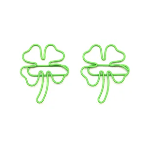 Detail shot of green four leaf clover metal paper clips, perfect for cute stationery office.