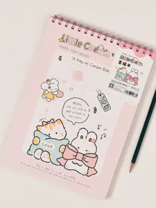Detail view of the pink A4 cute cartoon sketchbook with spiral binding and lovely cat illustrations.