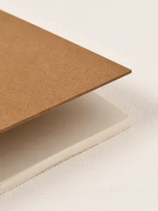 Detailed close-up view showing the textured brown kraft paper cover and white interior pages.
