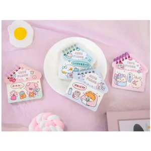 Close-up detail of cute house-shaped spiral notebooks with kawaii animal illustrations.