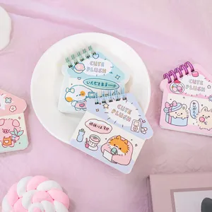 Detailed view of cute house-shaped spiral notebooks with lovely cartoon animal covers.