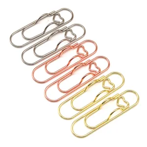 Metal heart-shaped paper clips and pen holders, creative office stationery supplies set.