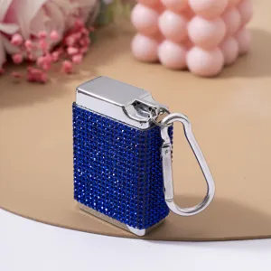 Detailopname van een draagbare sigarettenkoker met blauwe strass-steentjes en sleutelhanger