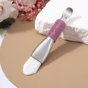 Elegant double-ended facial mask brush with soft white bristles and pink rhinestones