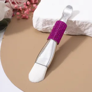 Double-ended facial mask brush with elegant purple rhinestone handle and soft bristles