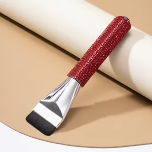 Detailed shot of a flat top foundation brush with sparkling red rhinestone handle
