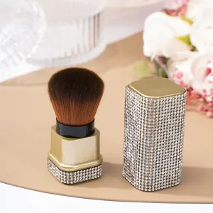 Luxury gold rhinestone nail dust brush with soft brown bristles and protective cap