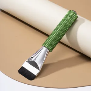 Close-up detail of straight foundation brush with luxury green rhinestone studded handle